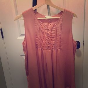 Peach colored sleeveless blouse